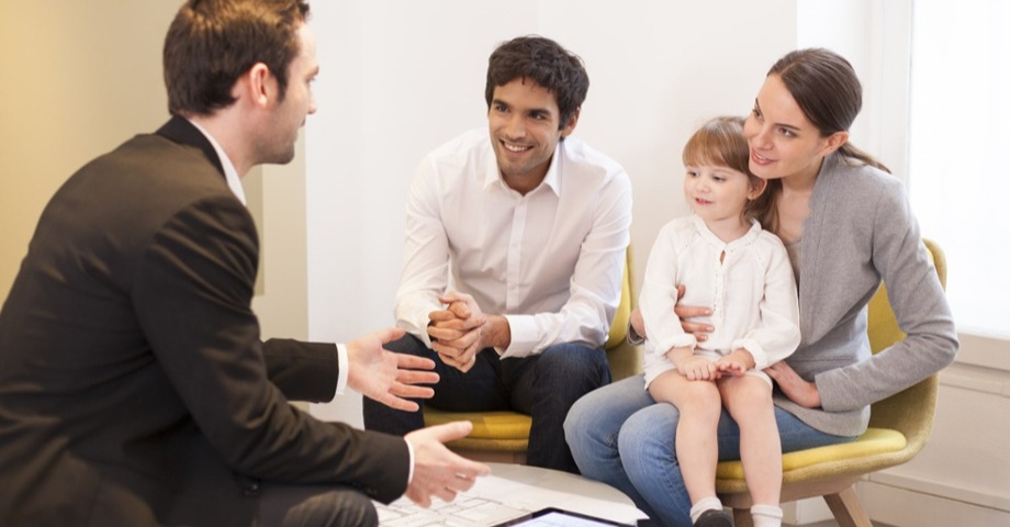 Young family meeting with a man who works for the bank 